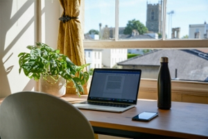 Laptop on a desk overlooking a city